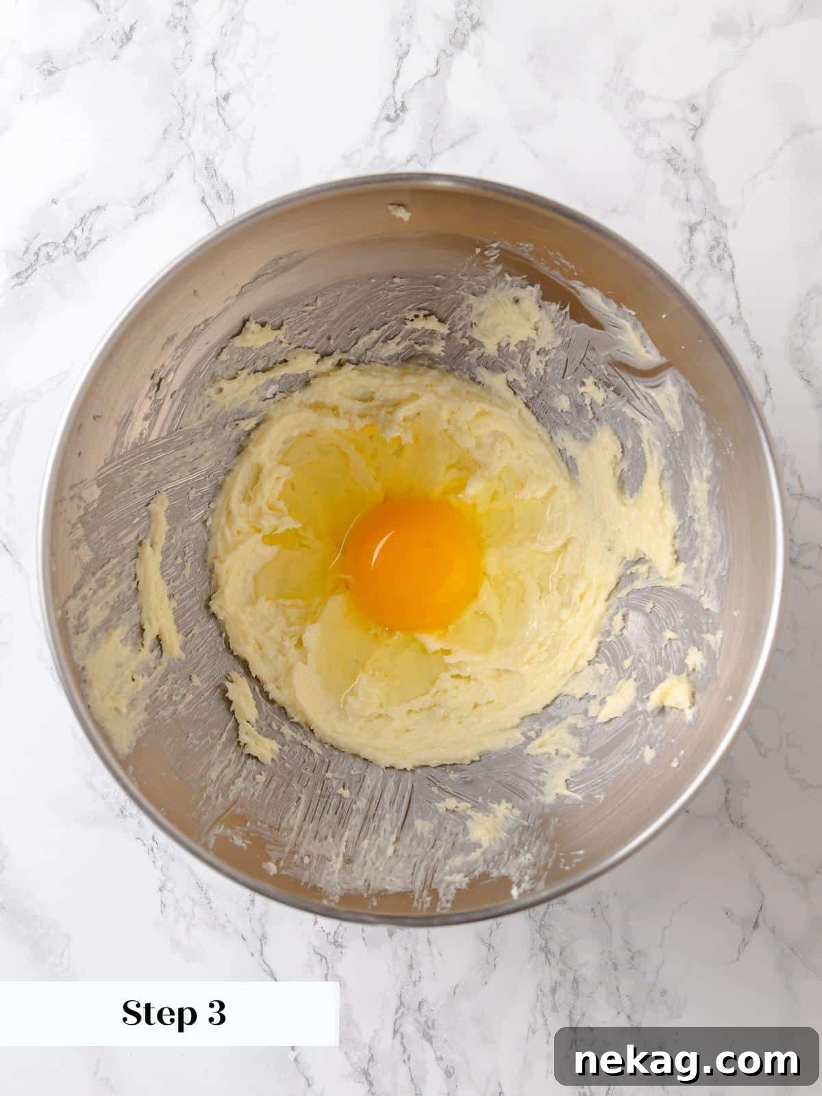 One large egg is carefully incorporated into the creamed butter and sugar, adding crucial moisture and richness to the batter.