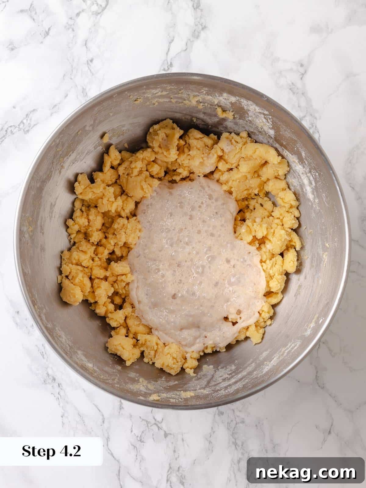Activated yeast mixture is added to the butter mixture to begin building the rich and flavorful dough.