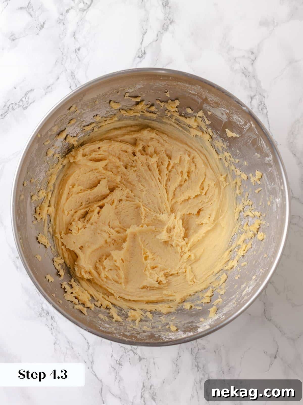 Smoothed dough in the pan forms a soft and even base, perfectly prepared for rising and the addition of the signature gooey topping.