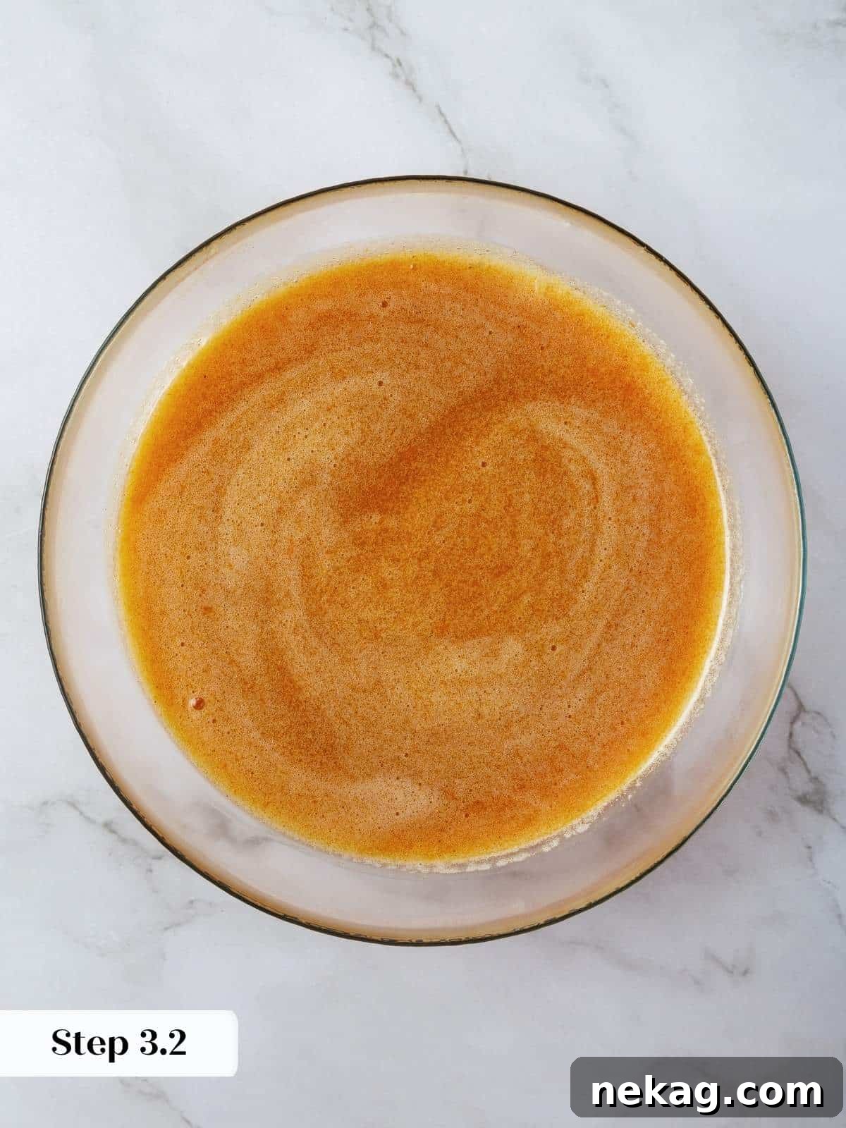 Mediterranean Pumpkin Delight 7 The wet ingredients (olive oil, pumpkin, sugars, eggs) are fully emulsified in a mixing bowl, creating a silky, smooth, and vibrant pumpkin-orange base for the cake batter.