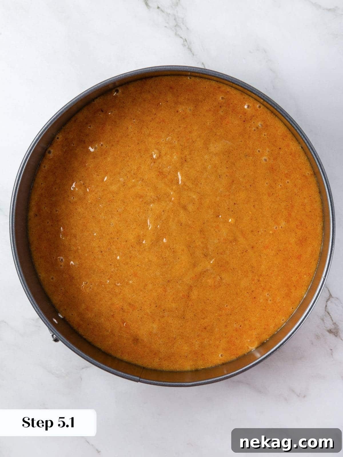 Mediterranean Pumpkin Delight 9 A 9-inch round cake pan is filled with the golden-orange pumpkin batter, smoothed across the top with an offset spatula, ready for baking.