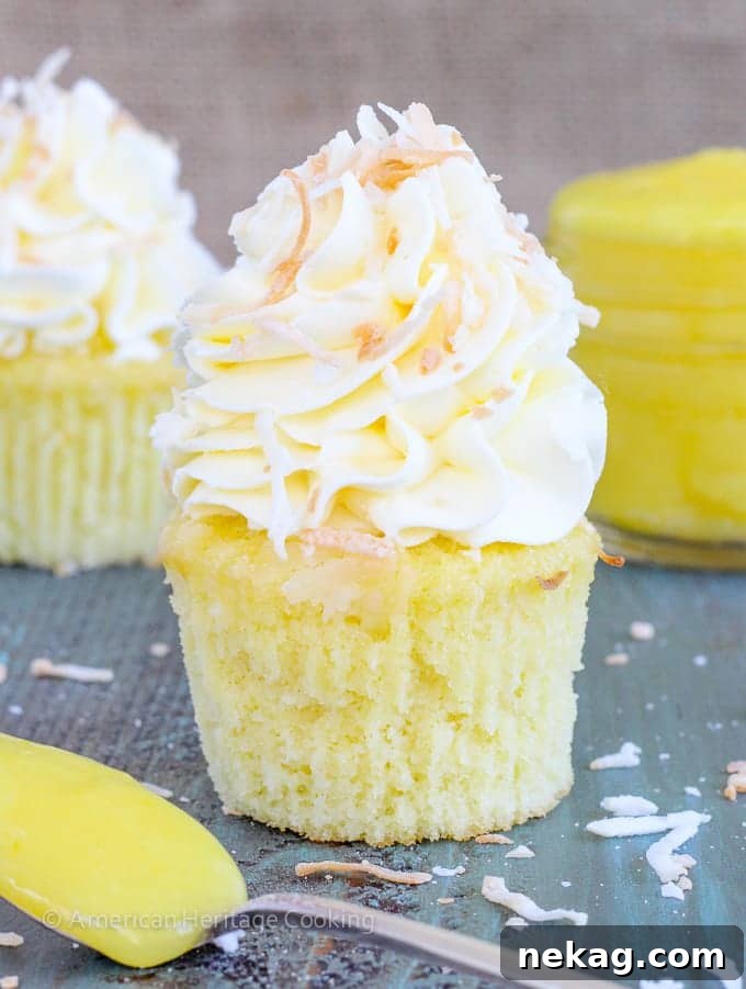 Lemon & Coconut Cloud Cupcakes 5 A batch of freshly baked lemon coconut cupcakes cooling on a wire rack.