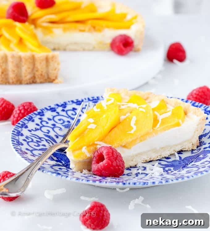 Sunshine Mango Coconut Tart 3 Close-up of a Coconut Mango Tart, showcasing the fresh mango slices