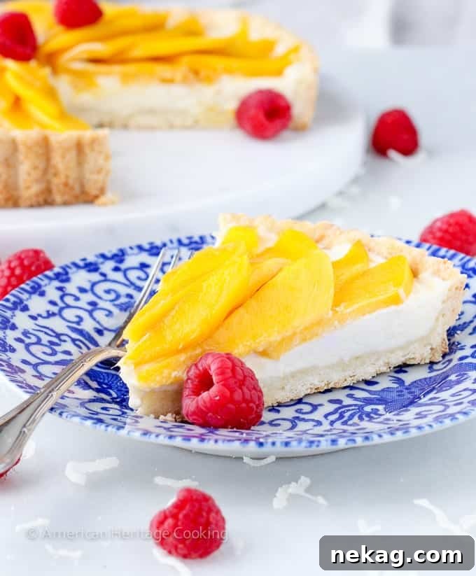 Sunshine Mango Coconut Tart 7 Close up of Coconut Mango Tart, garnished with fresh raspberries