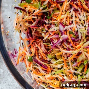 Cabbage and broccoli slaw blend shown with visible texture from shredded vegetables and toasted seeds.