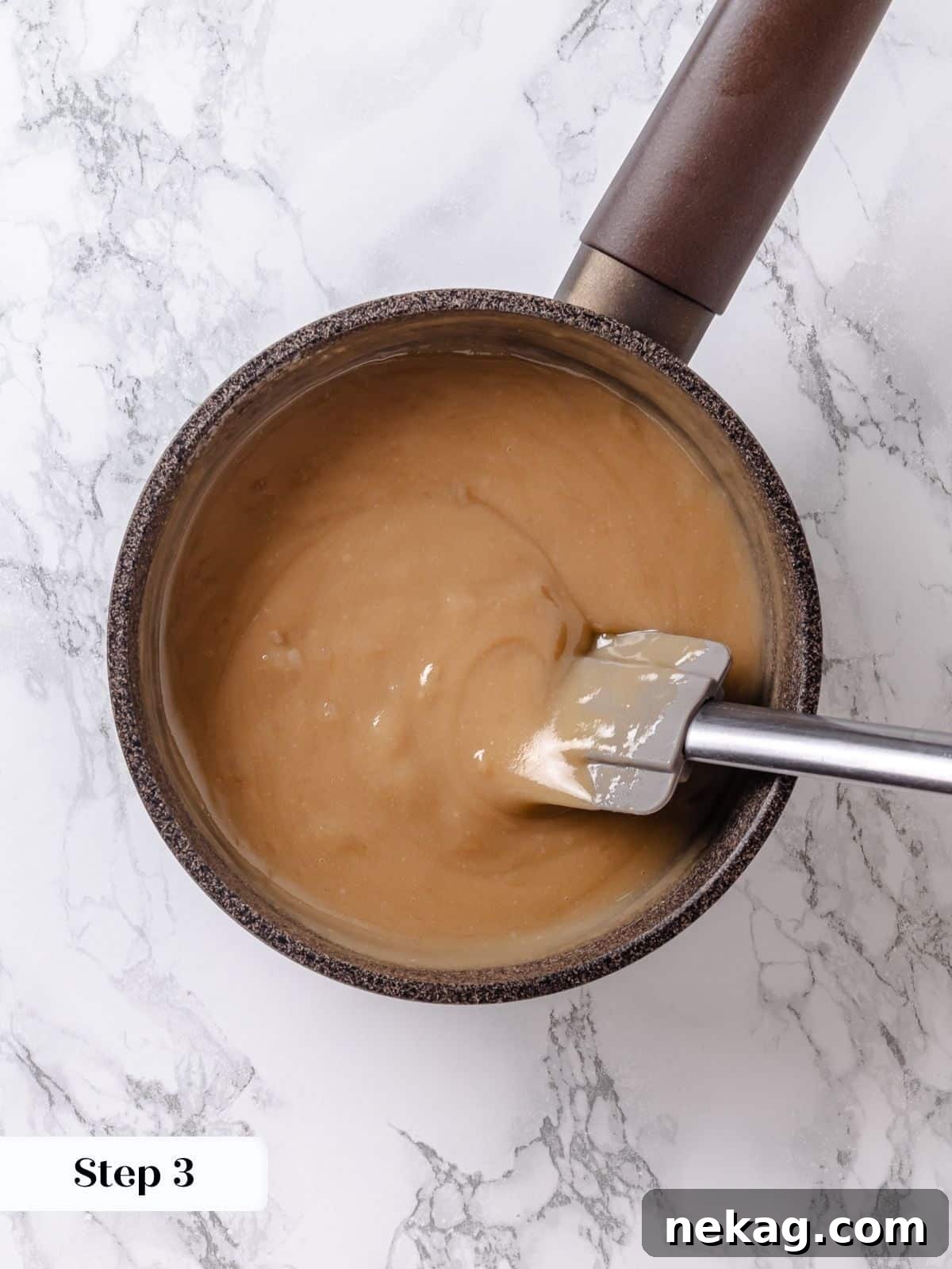 Velvet Maple Glaze 8 The maple frosting base is constantly scraped with a silicone spatula across the saucepan to prevent burning and ensure even cooking.