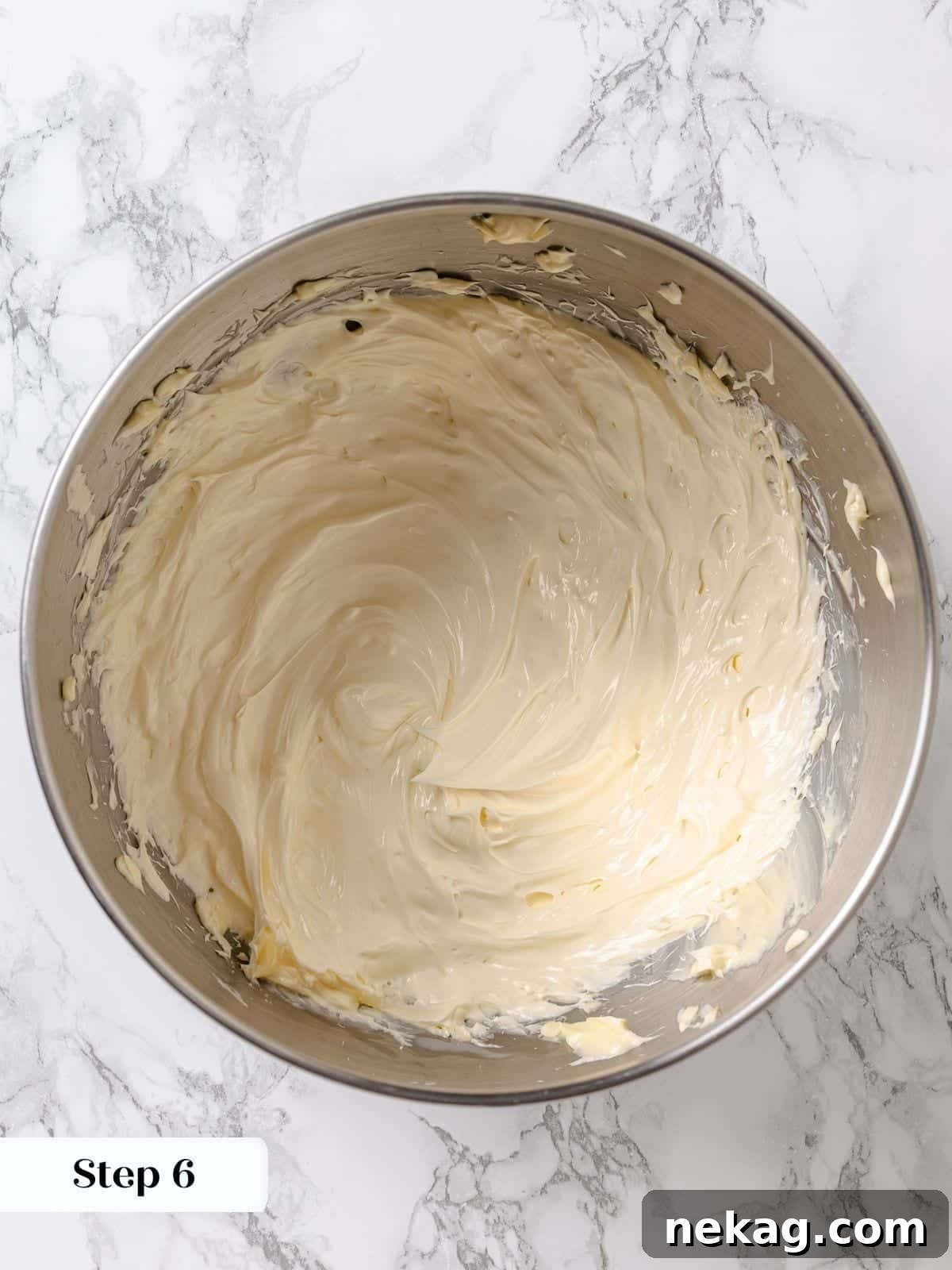 Velvet Maple Glaze 10 Unsalted butter is beaten in a stand mixer until light, fluffy, and almost white, preparing it to receive the cooled maple frosting base.