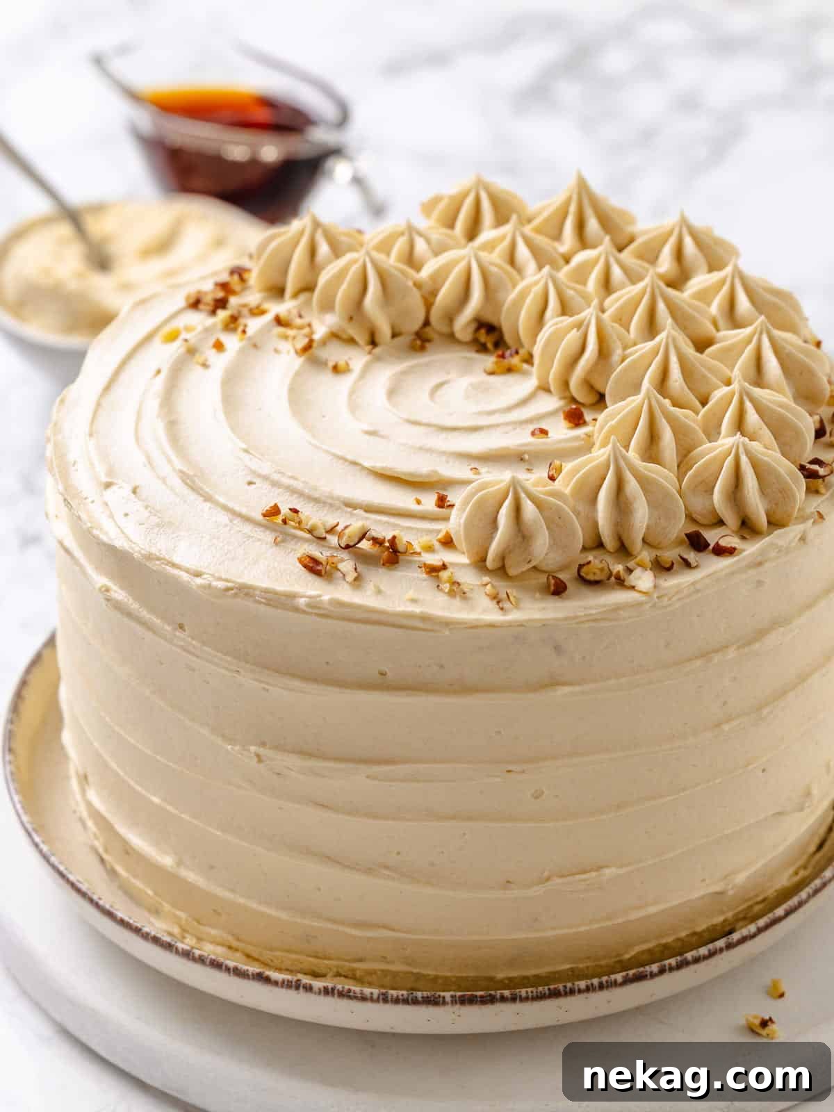 Golden Maple Delight 20 A perfectly sliced maple cake resting on a pristine white plate, showcasing fluffy frosting beautifully layered across its tender crumb.