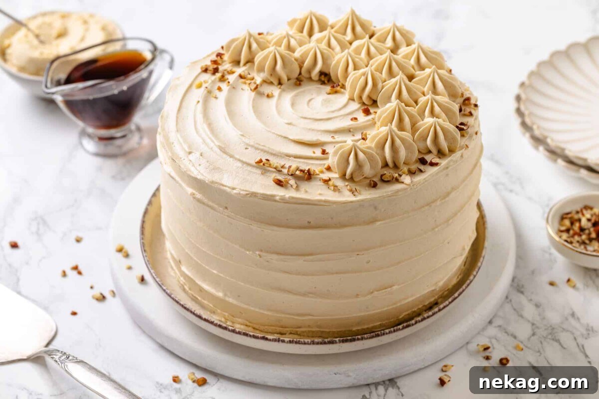 Golden Maple Delight 4 Beautifully frosted maple cake, left whole and unsliced, showcasing its smooth exterior.