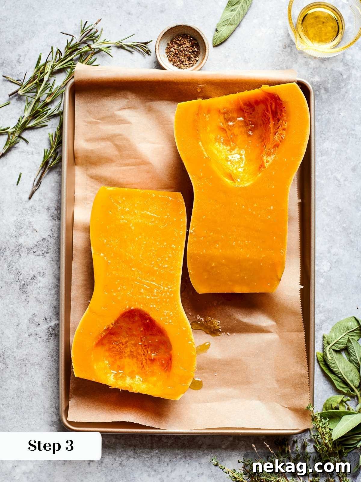 Butternut squash precisely cut in half lengthwise, with its seeds and fibrous strands cleanly scooped out, ready for seasoning and roasting to maximize flavor for the soup.