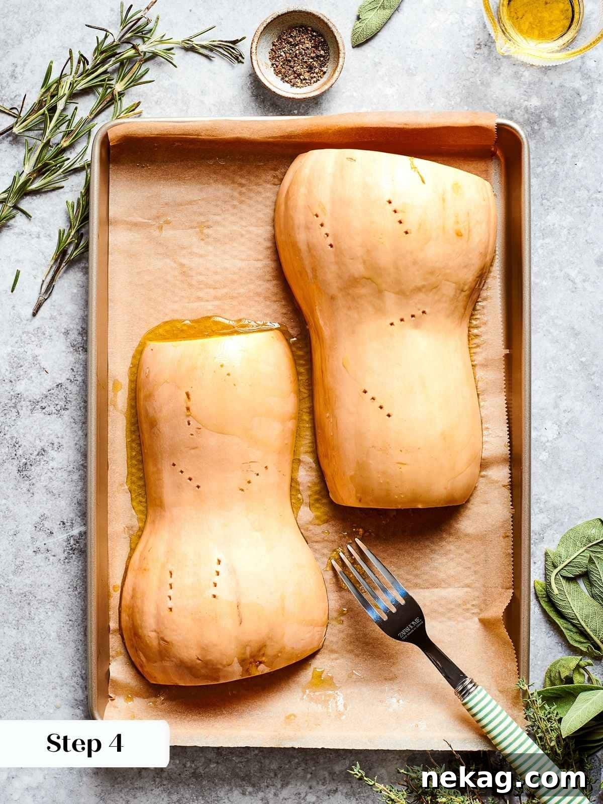 Butternut squash halves, seasoned and drizzled with olive oil, arranged cut-side down on a parchment-lined baking sheet, prepared for roasting to achieve perfect caramelization.