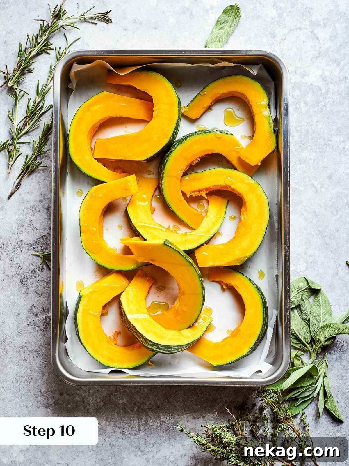 Uniform chunks of raw kabocha squash, skins on, arranged neatly on a parchment-lined baking sheet, seasoned and ready to be roasted to tender perfection.