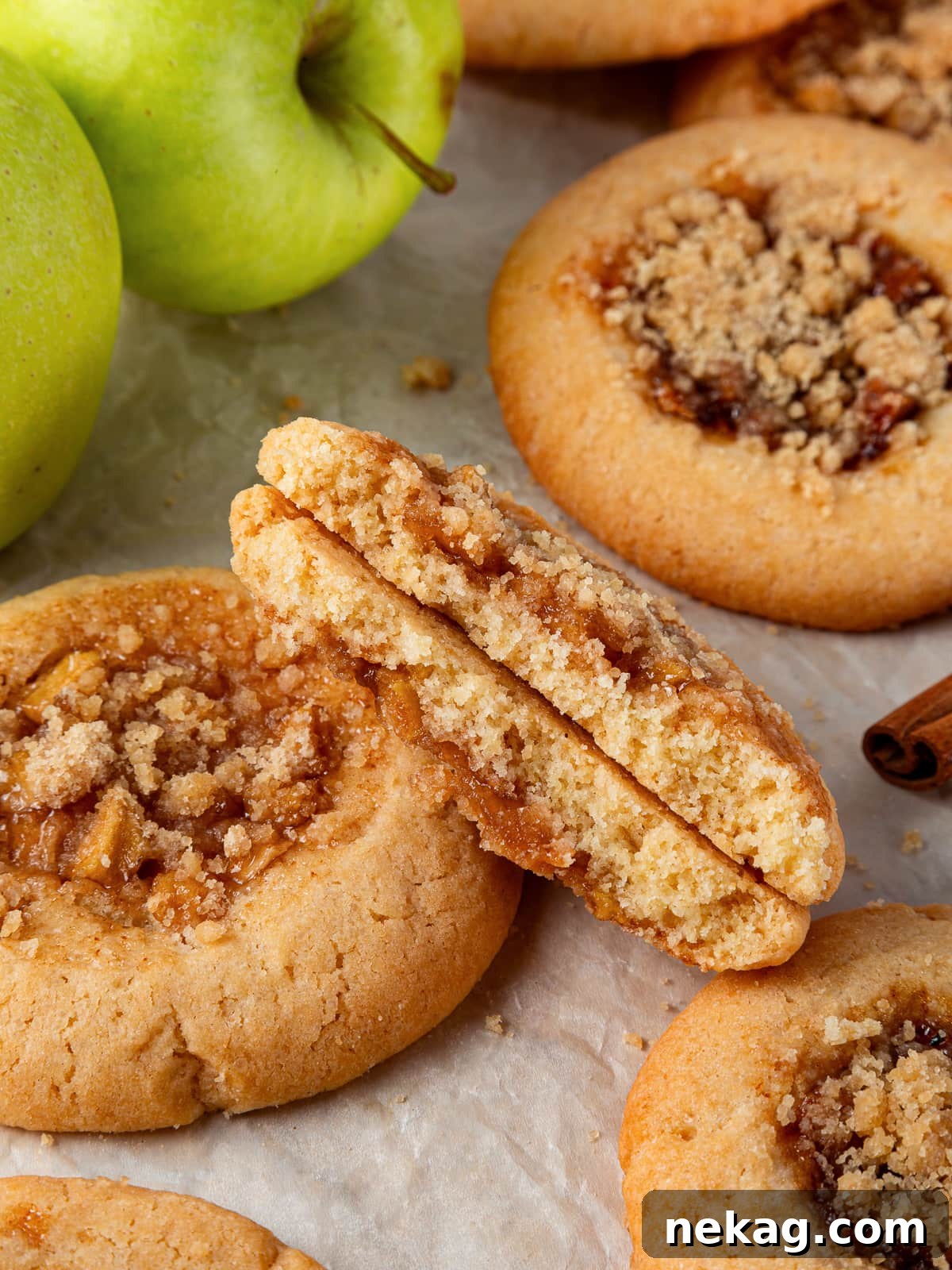 Apple Crumble Cookies 2 Cookie broken in half revealing gooey apple filling inside a chewy brown sugar dough.