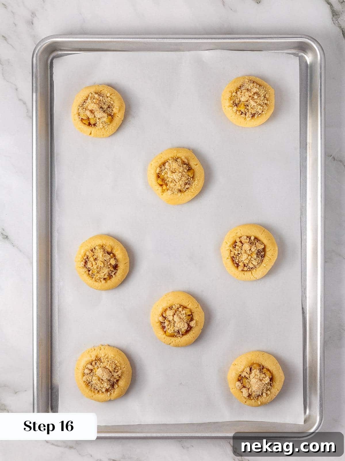 Apple Crumble Cookies 14 Unbaked apple pie cookies topped with brown sugar crumble before heading into the oven.