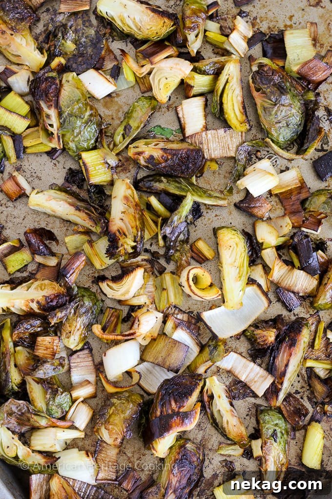 Close-up of crispy roasted Brussels sprouts and leeks, glistening with honey, perfect for a healthy and filling meal.
