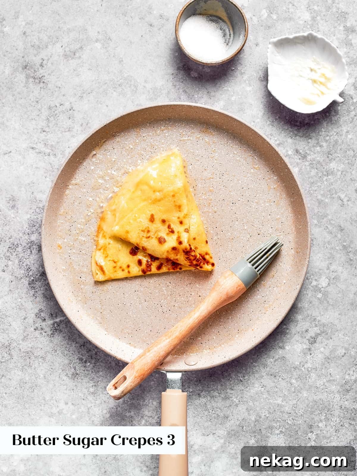 Golden crepe folded again to create a classic triangle perfect for butter and sugar.
