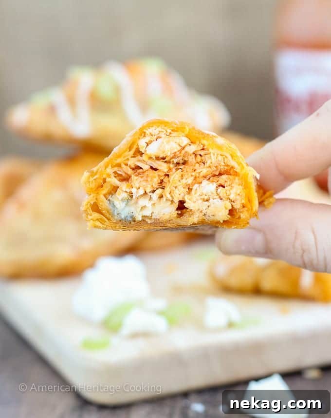 Spicy Buffalo Chicken Blue Cheese Hand Pies 5 Individual Buffalo Chicken Blue Cheese Hand Pies, beautifully crimped and arranged on a baking sheet before baking.