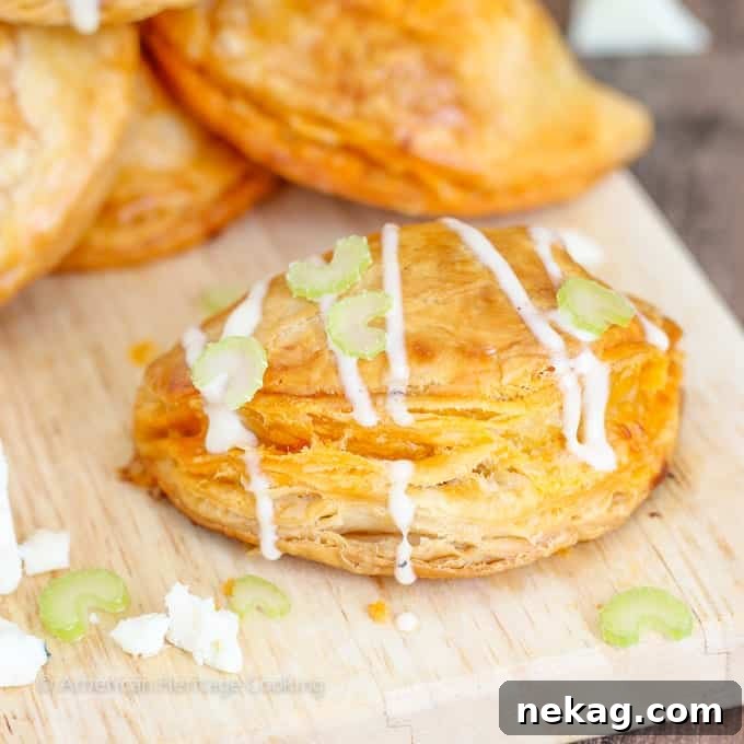 Spicy Buffalo Chicken Blue Cheese Hand Pies 6 Plated Buffalo Chicken Blue Cheese Hand Pies, beautifully presented with a side of blue cheese dressing and crisp celery sticks.