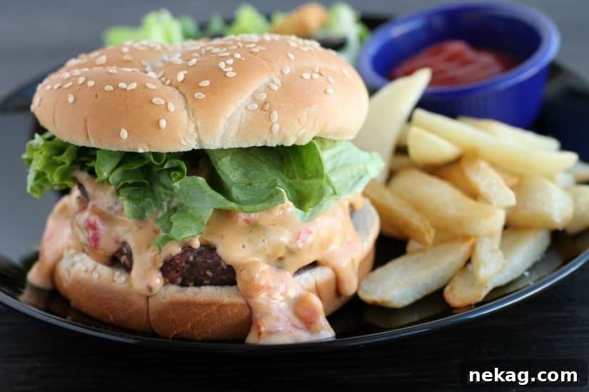 Gooey Queso Burgers 3 Close-up of a skillet filled with rich, creamy queso dip with Ro*Tel tomatoes