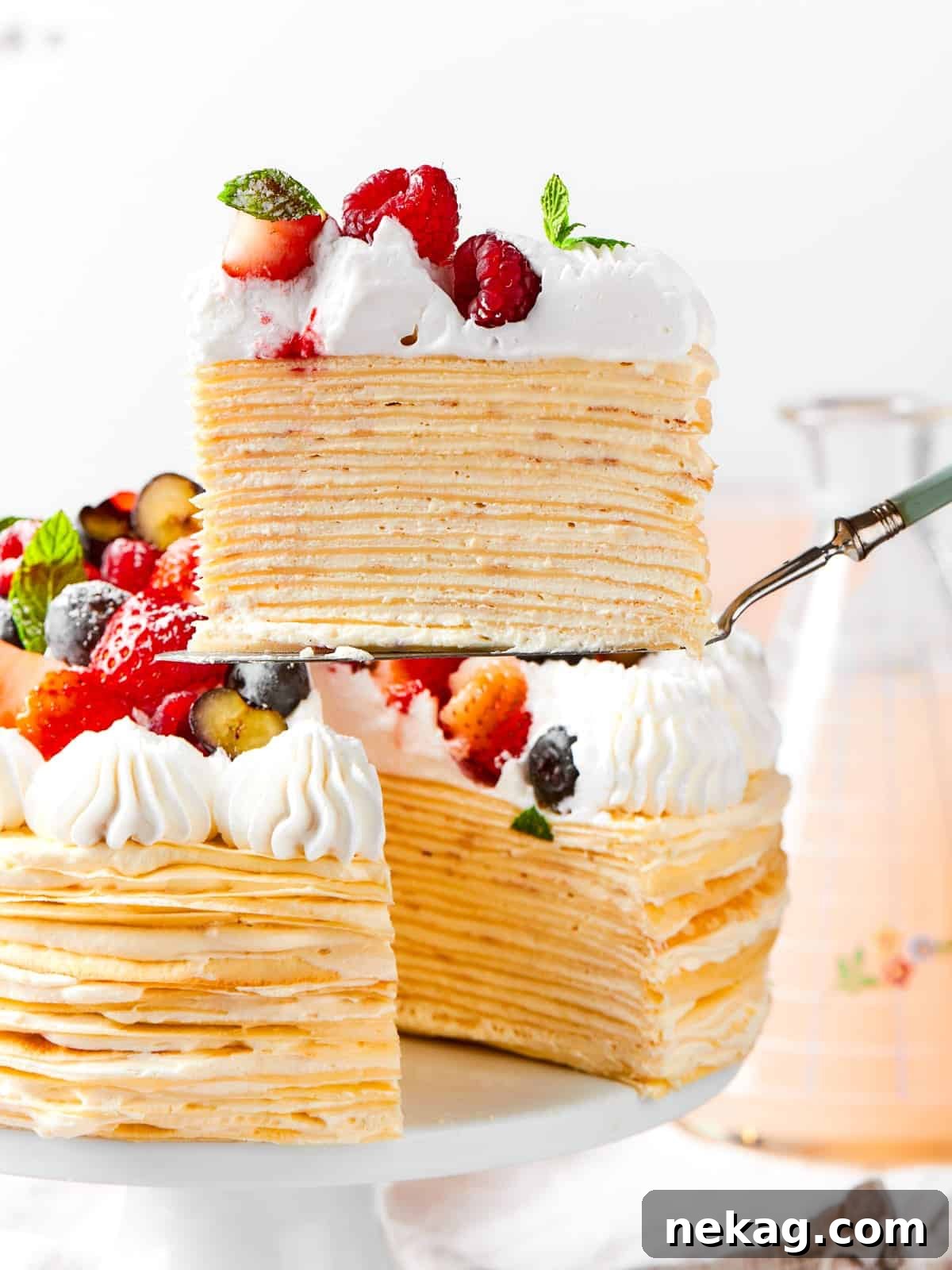 Delicate Layered Crepe Dessert 17 The cake reveals its layered crepes and vanilla cream after a slice has been taken out.