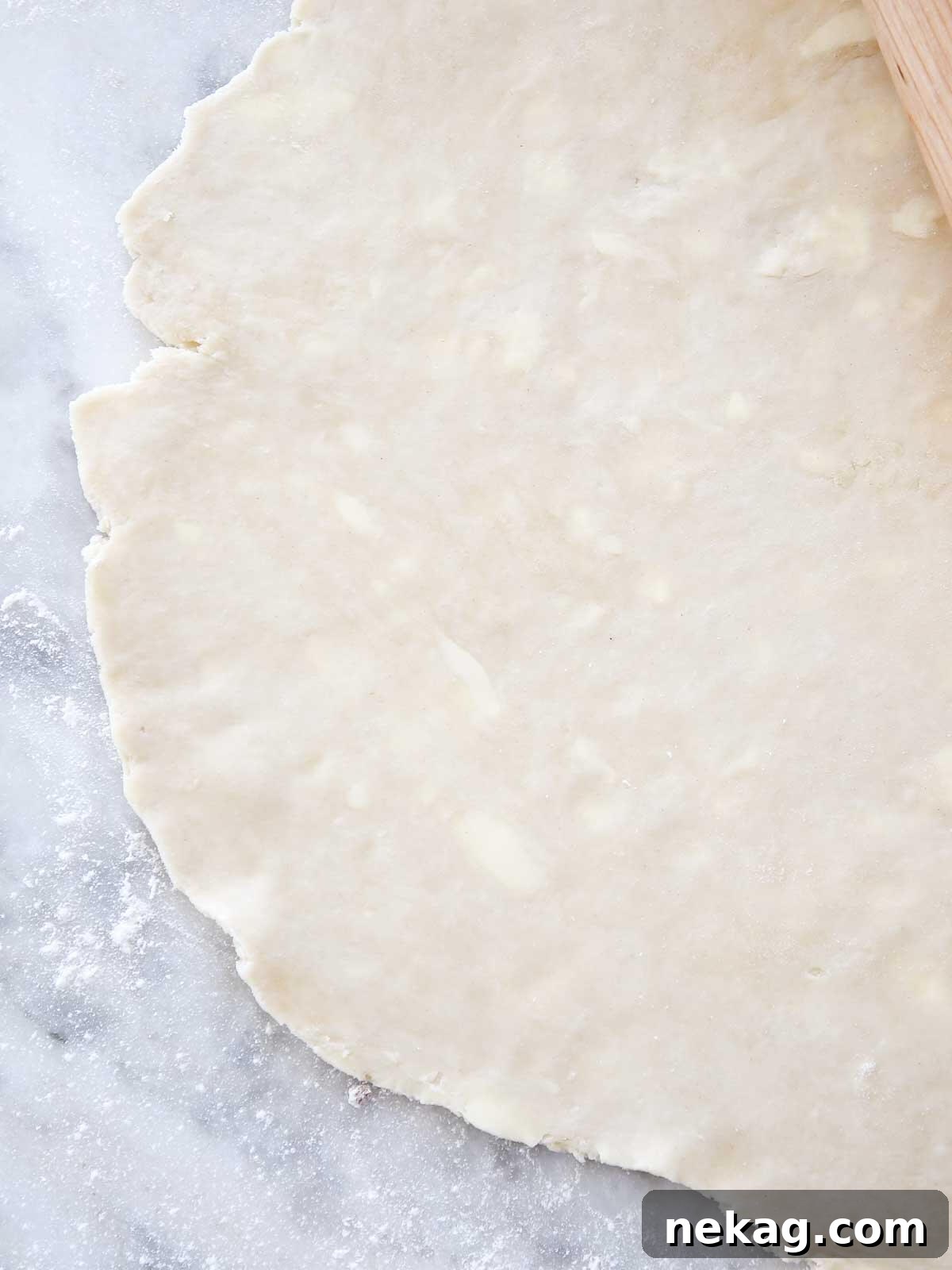 Flaky Butter Crust Perfection 2 Thinly rolled all-butter pie crust showing visible flecks of butter, ready for baking.