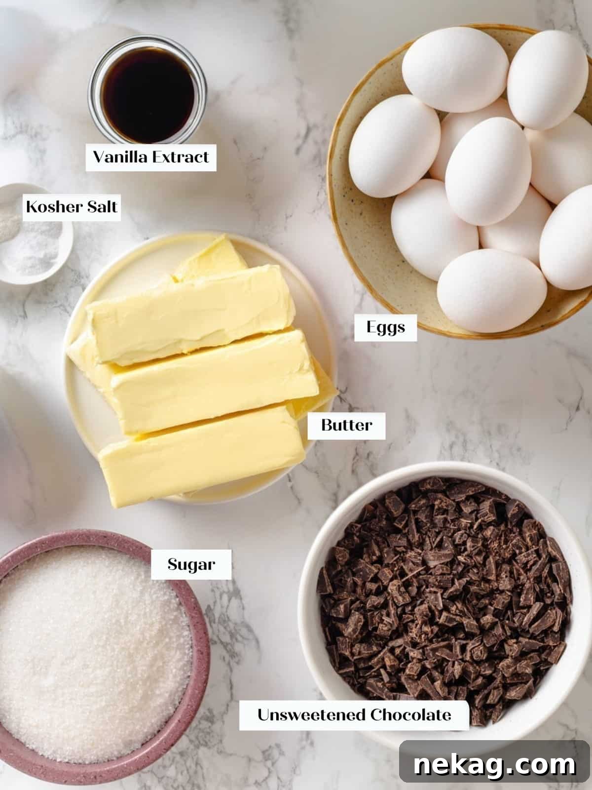 All ingredients for making chocolate buttercream laid out neatly before starting the recipe, emphasizing fresh egg whites, unsalted butter, and unsweetened chocolate.