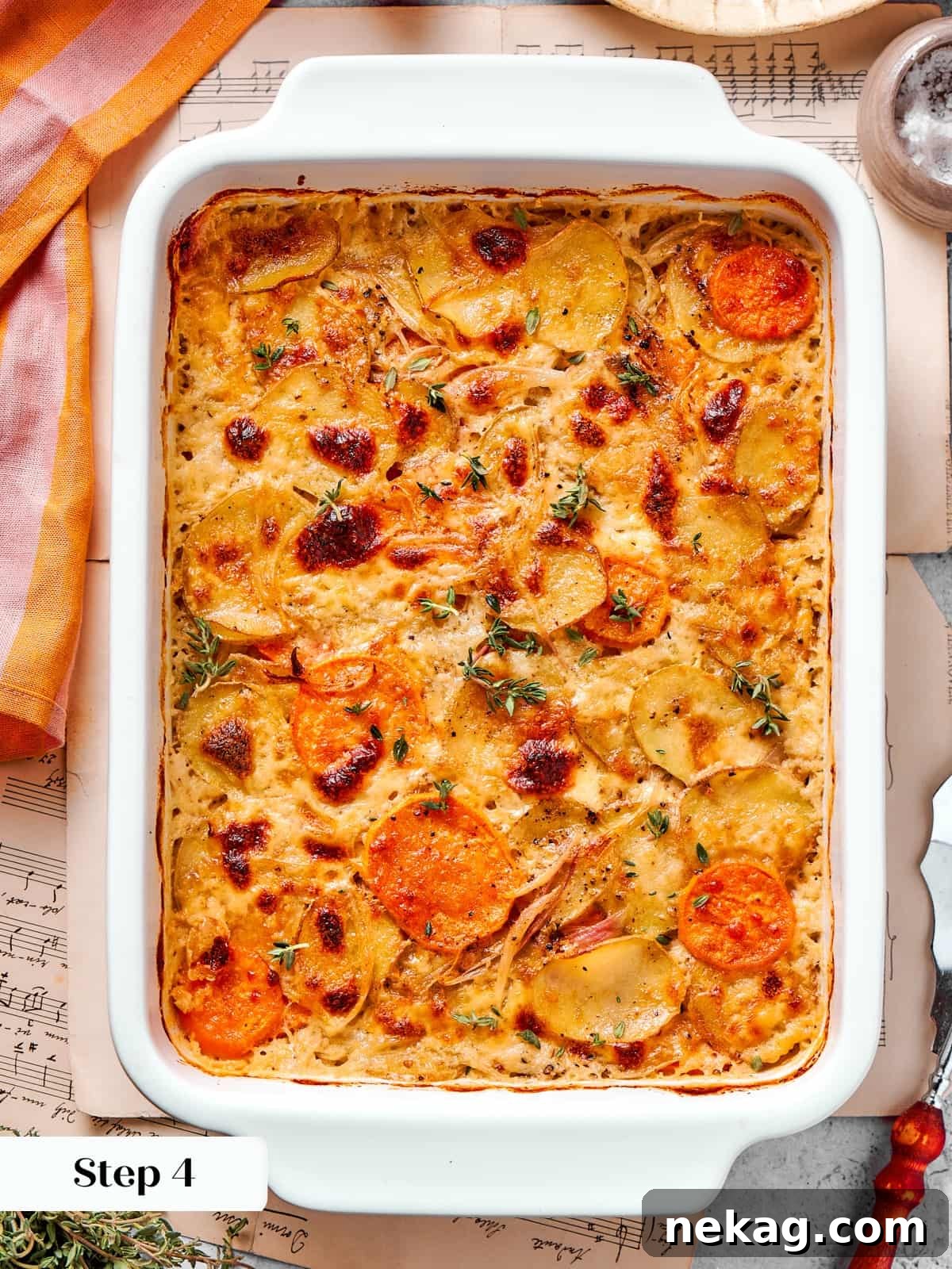 Scalloped potatoes mid bake showing bubbling cheese sauce and lightly browned edges.