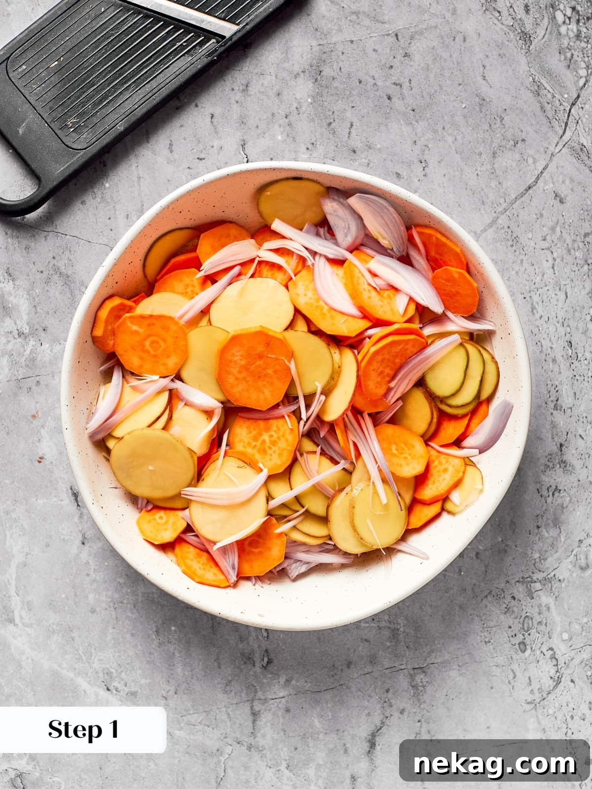 Thin potato and shallot slices prepared using a mandolin slicer.
