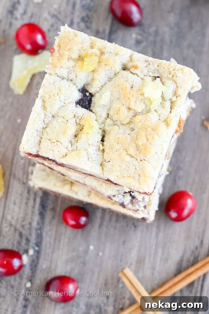 Spiced Cranberry Crumble Bars 4 A tray of freshly baked Cranberry Cinnamon Jam Bars, glistening with cranberry filling and golden streusel topping, ready to be sliced.