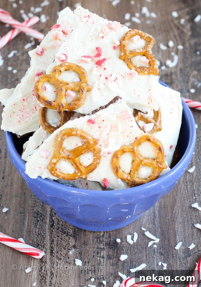 This easy Coconut Peppermint Pretzel Bark is a minty mix of white and dark chocolate with candy cane "snow", salty pretzels and a hint of coconut! You will love the holiday mint flavor! 