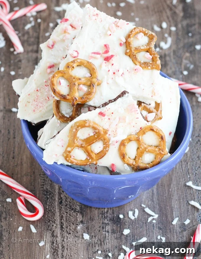 This easy Coconut Peppermint Pretzel Bark is a minty mix of white and dark chocolate with candy cane "snow", salty pretzels and a hint of coconut! You will love the holiday mint flavor! 