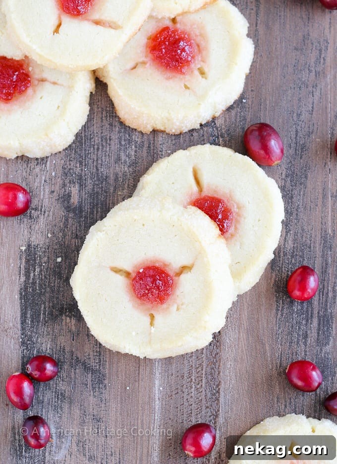 Yuletide Jammy Treasures 6 A stack of golden-brown Cranberry Thumbprint Cookies, showcasing the refrigerator log method.