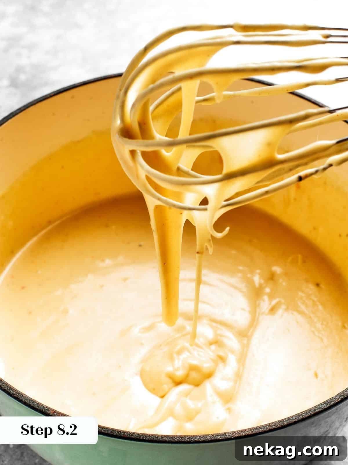 Ultimate Baked Mac and Cheese 13 A rich, creamy mac and cheese sauce, perfectly blended with vibrant seasonings, showcasing its smooth texture and golden hue.