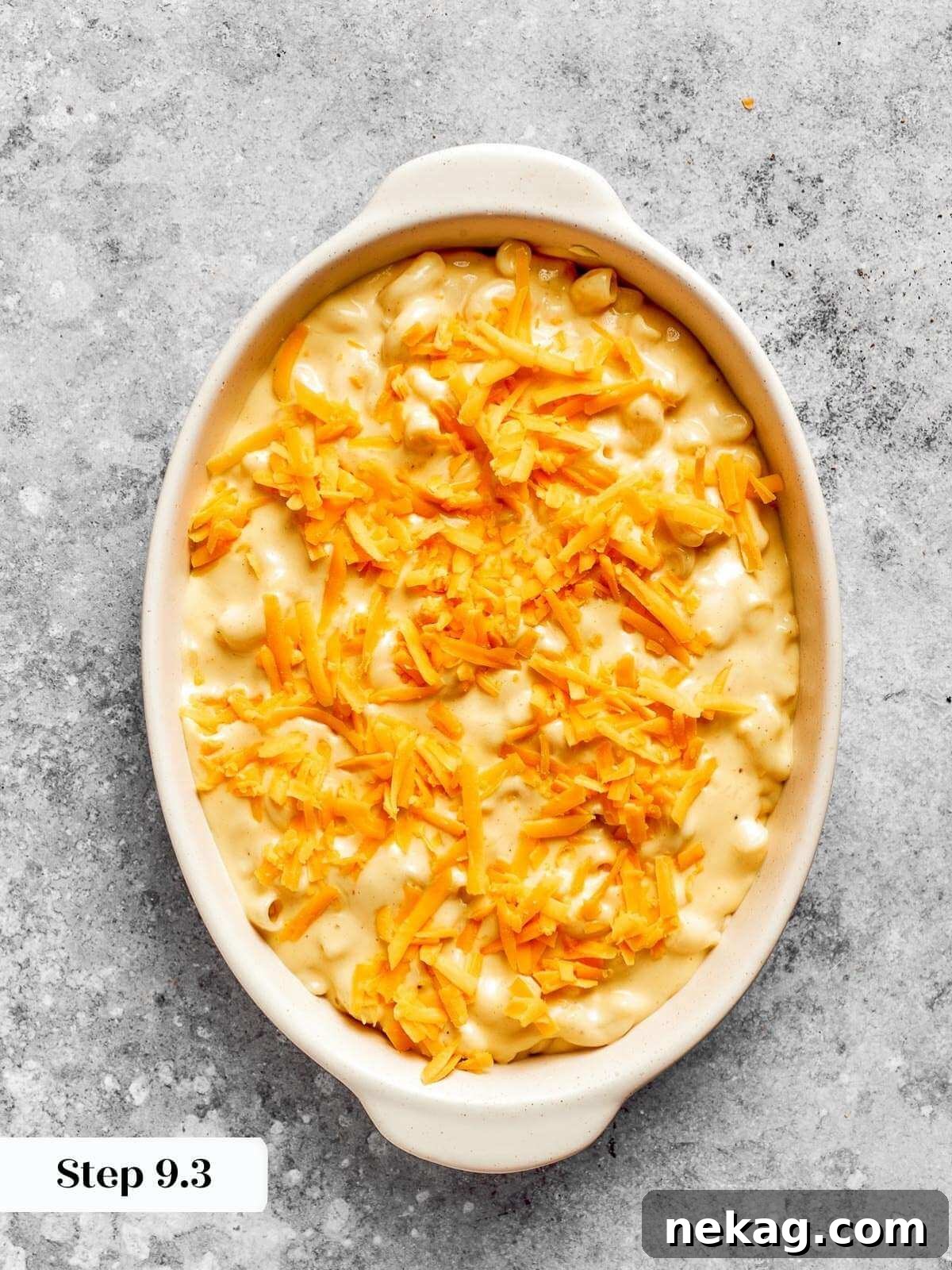 Ultimate Baked Mac and Cheese 16 The assembled mac and cheese, topped with reserved shredded cheese, in a baking dish, perfectly poised to go into the oven for baking.