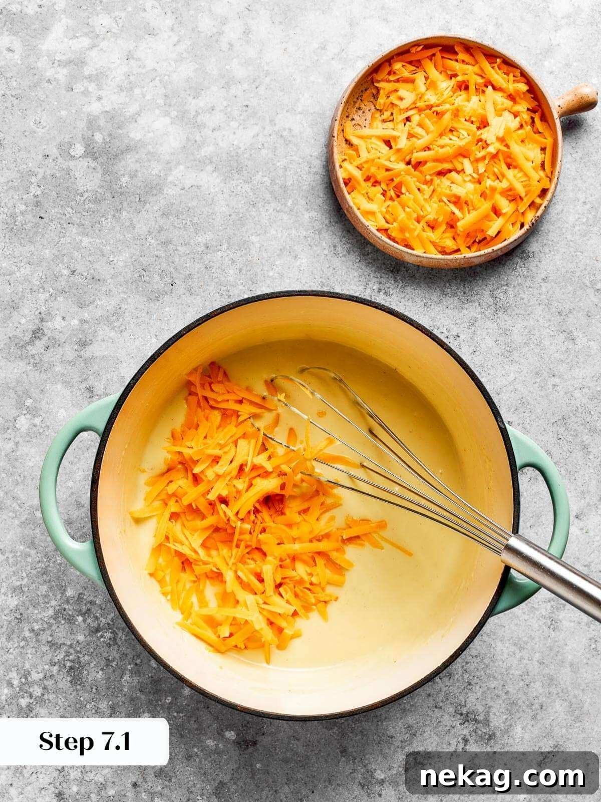 Ultimate Baked Mac and Cheese 10 Freshly shredded cheddar cheese melting into a warm, thick roux, forming a luscious and cohesive mac and cheese sauce.