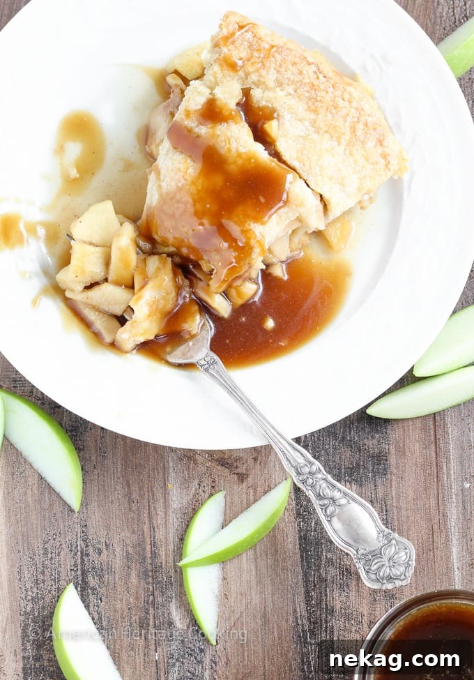 A beautifully baked Apple Butterscotch Pie with a lattice top, presented on a rustic wooden surface.