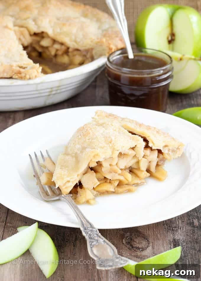 A close-up of a rustic Apple Butterscotch Pie, focusing on the texture of the homemade crust and the visible apple chunks.