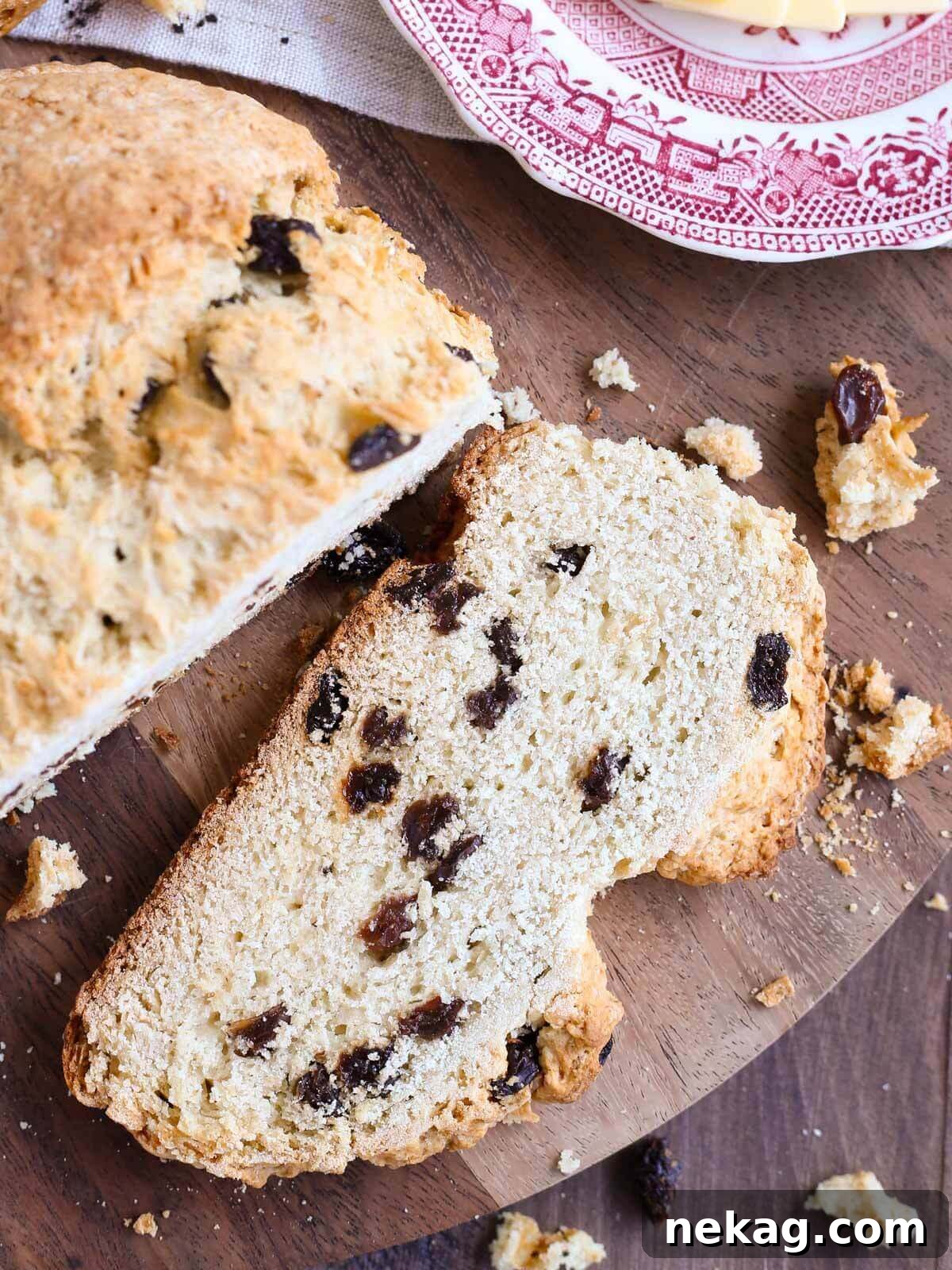 Emerald Isle Raisin Loaf 3 A close-up slice of traditional Irish soda bread with visible raisins and a tender crumb.