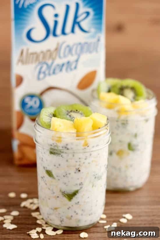 Paradise Overnight Oats 5 Delicious Tropical Overnight Oats in a jar, garnished with fresh kiwi and pineapple, ready to eat.