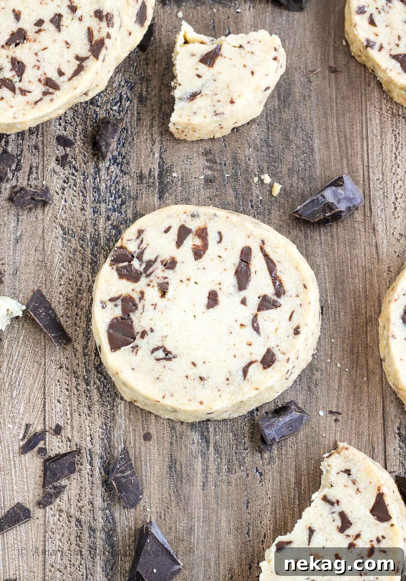 Divine Chocolate Chip Shortbread 2 Soft and moist chocolate chip shortbread cookies artfully arranged on a rustic wooden background, inviting a delightful indulgence.