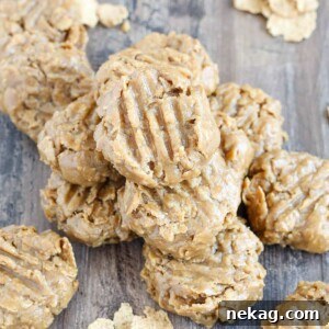 No Bake Peanut Butter Cookies stacked on wooden surface.