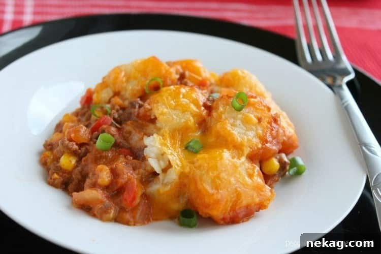 A close-up of the delicious baked Sloppy Joe Tater Tot Casserole with golden cheese and tots