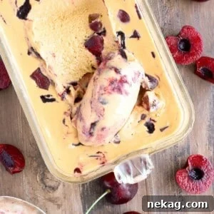 Bourbon Caramel Cherry Ice Cream being scooped with spoon