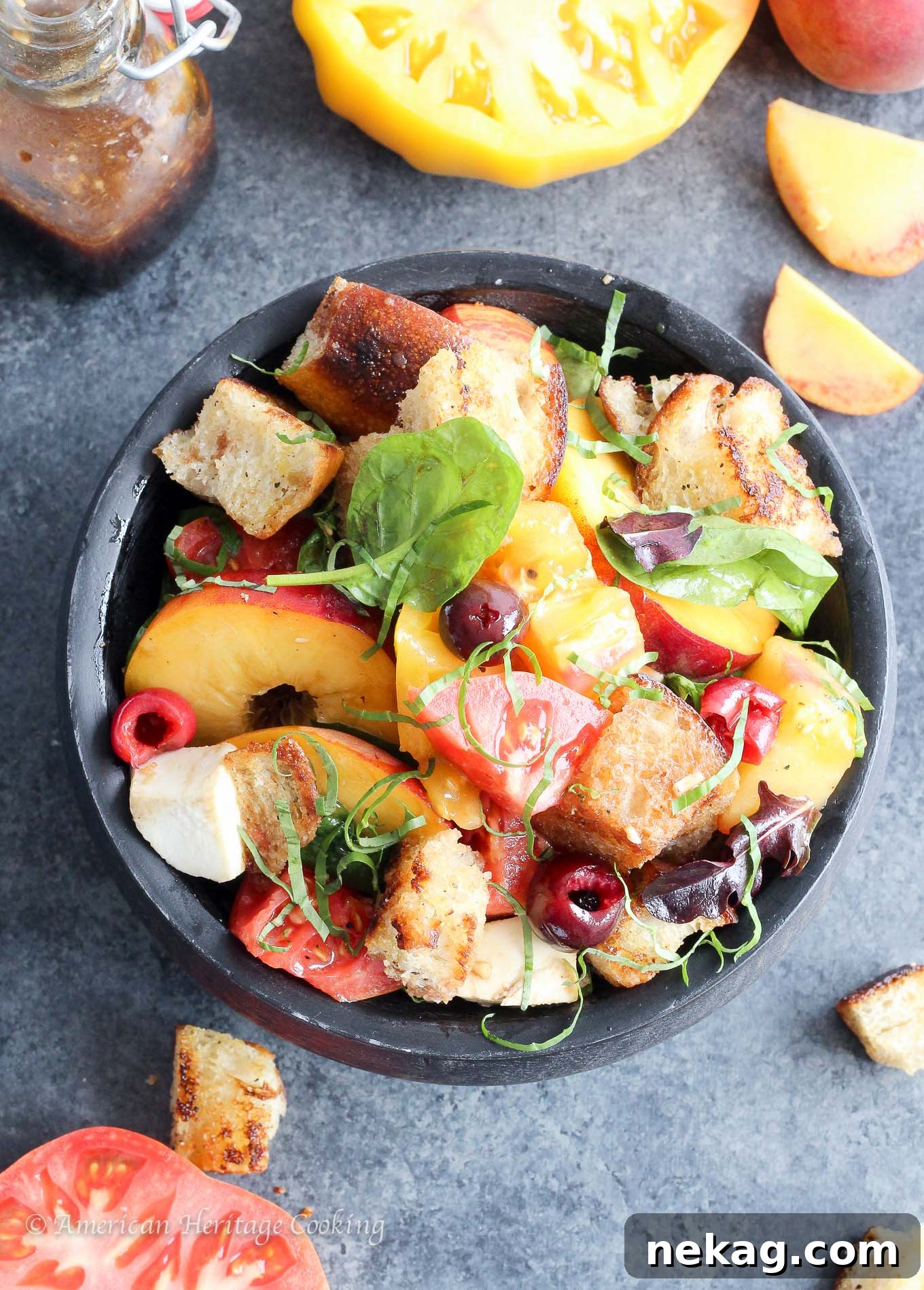 Orchard Caprese Panzanella 4 Beautifully arranged Stone Fruit Caprese Panzanella Salad presented in a dark wooden bowl on a rustic surface.