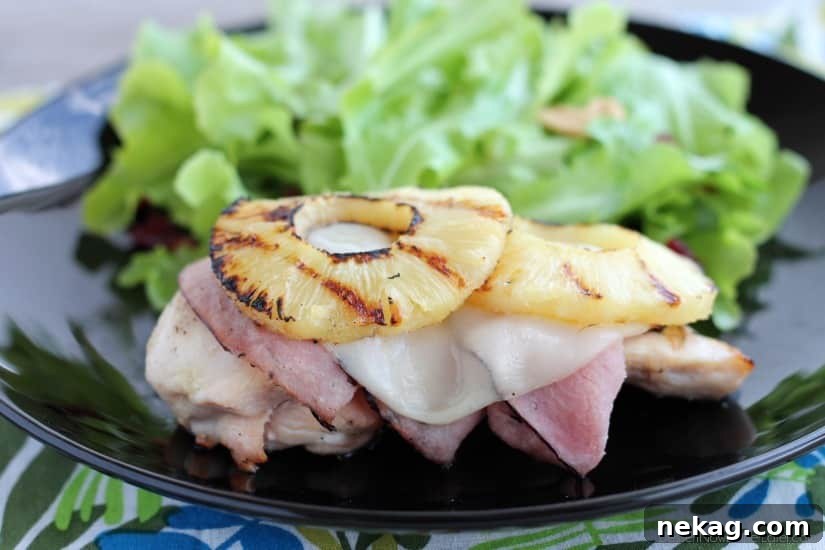 Grilled Malibu Chicken close-up, showing melted cheese, ham, and pineapple on tender chicken breast