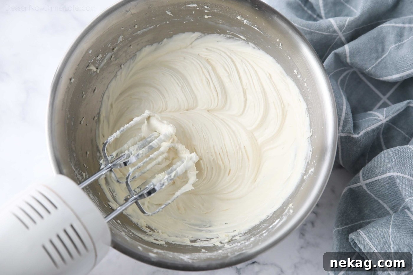 Ultimate Cream Cheese Frosting Recipe 2 Cream cheese frosting made in a bowl with an electric hand mixer.