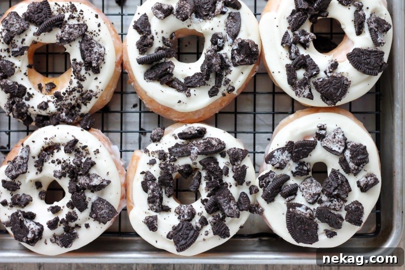A beautiful stack of freshly prepared Cookies and Cream Donuts on a white serving plate, showcasing their inviting appearance.