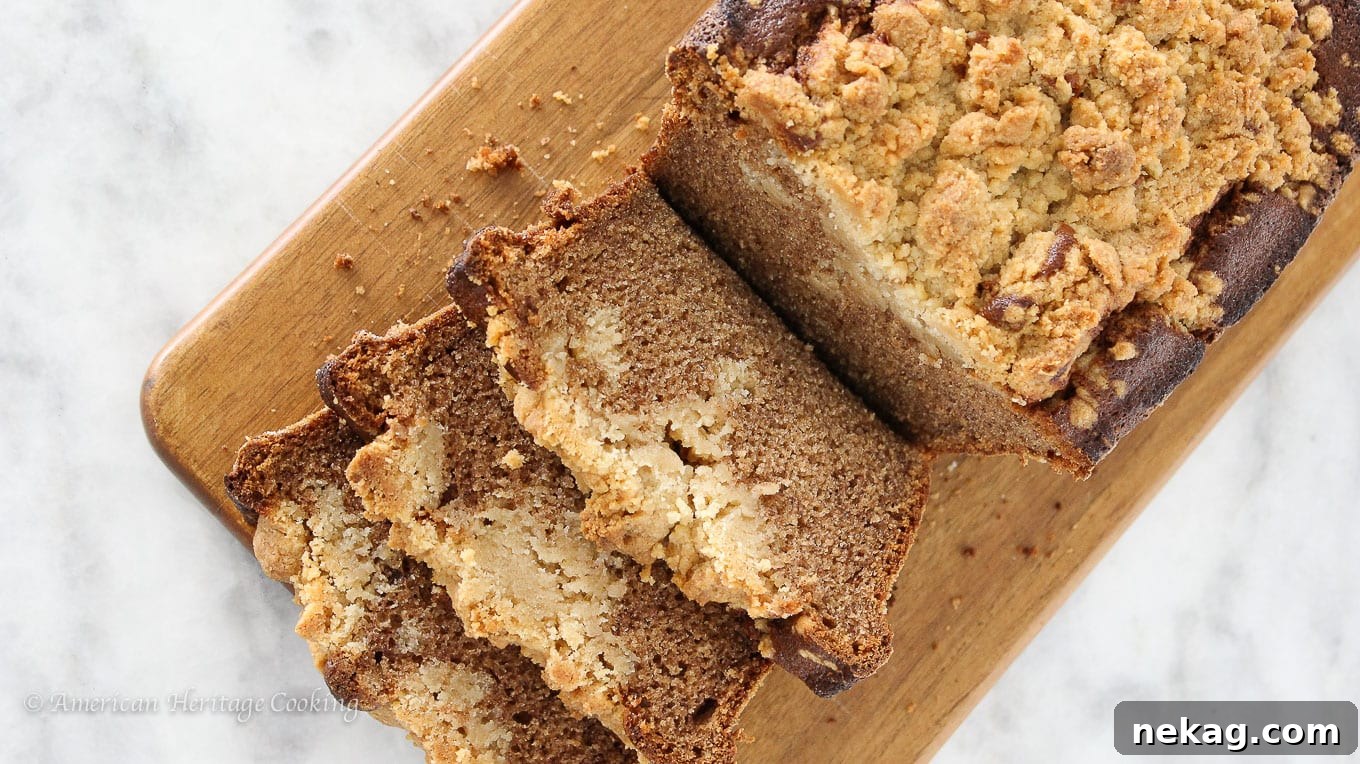 Close-up of cinnamon banana crumb bread with a rich, textured streusel topping, ready to be sliced.