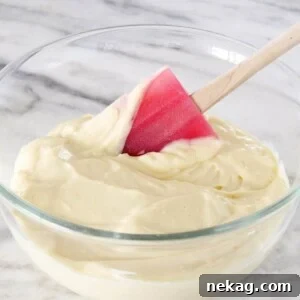 Pastry cream with a red silicone spatula.