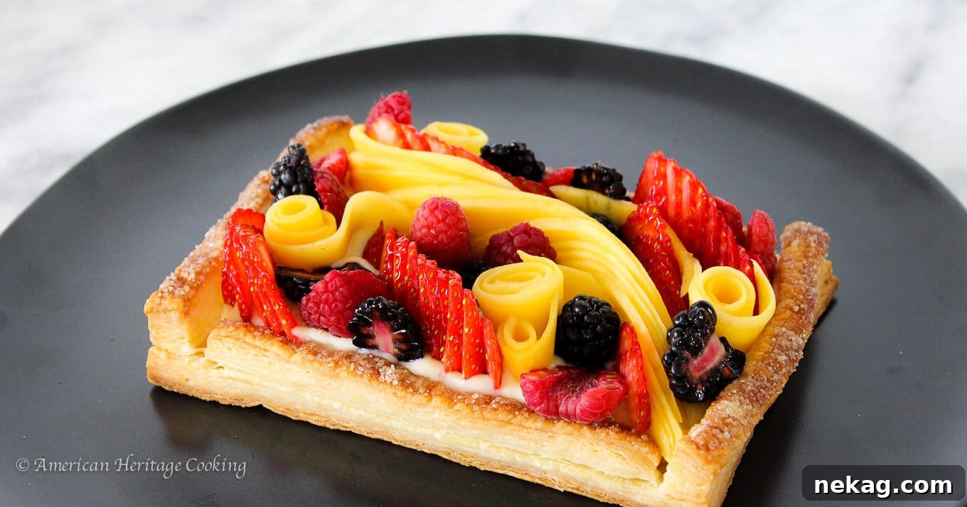 Vibrant Fruit Puff Pastry 3 Flaky layers of puff pastry crust with a generous topping of fresh fruit, highlighting the golden-brown edges.